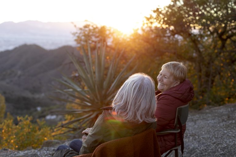 two-senior-women-nature-escapade-sitting-chairs-enjoying-their-time